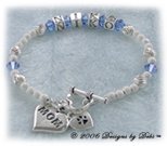 Designs by Debi handmade Personalized Keepsake Bracelet in sterling silver with the name Niko in alphabet letter cubes, sapphire Swarovski crystal birthstones, a heart toggle clasp and a Mom heart charm. Also known as name bracelets, brag bracelets, Mother's bracelets, birthstone bracelets.