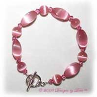 Designs by Debi Handmade Jewelry Pink Cat's Eye Twist and Round and Swarovski Crystal Rose Bicones Bracelet with a Silver Round Toggle Clasp