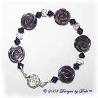 Designs by Debi Handmade Jewelry Purple Cat's Eye Carved Roses, Swarovski Crystal Amethyst Bicones, and Sterling Silver Rose Beads Bracelet with a Sterling Silver Rose Tab Clasp