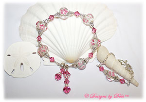 Designs by Debi Handmade Jewelry Aloha Collection Pink Bracelet and Anklet Set. Features large pink aloha floral rondelles, swarovski crystal rose bicones, silver filigree bead caps, dangles, a magnetic clasp and matching anklet.