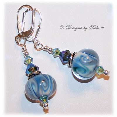 Designs by Debi Jewelry for Charity Set July 2011 Swirling Ocean Surf to benefit the American Red Cross. A beautiful, one of a kind handmade lampwork bracelet and earrings set in swirling blue, white and hints of green, swirled Bali silver beads, twisted rings and elegantly scrolled toggle clasp accented with Swarovski crystal bicones in aquamarine ab2x and montana ab2x. OOAK © Designs by Debi All Rights Reserved