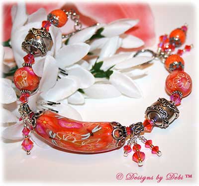 Can't Wait for Spring! Designs by Debi Jewelry for Charity Bracelet March 2011 A fun, one of a kind handmade bracelet of orange, pink and white polymer clay beads with flowers and dragonflies, Bali silver beads, Swarovski crystals and sterling silver. OOAK