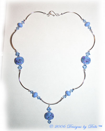 Morning Glory one-of-a-kind handmade artisan lampwork, Swarovski crystal and silver curved tube bead necklace in periwinkle blue with a hook clasp.